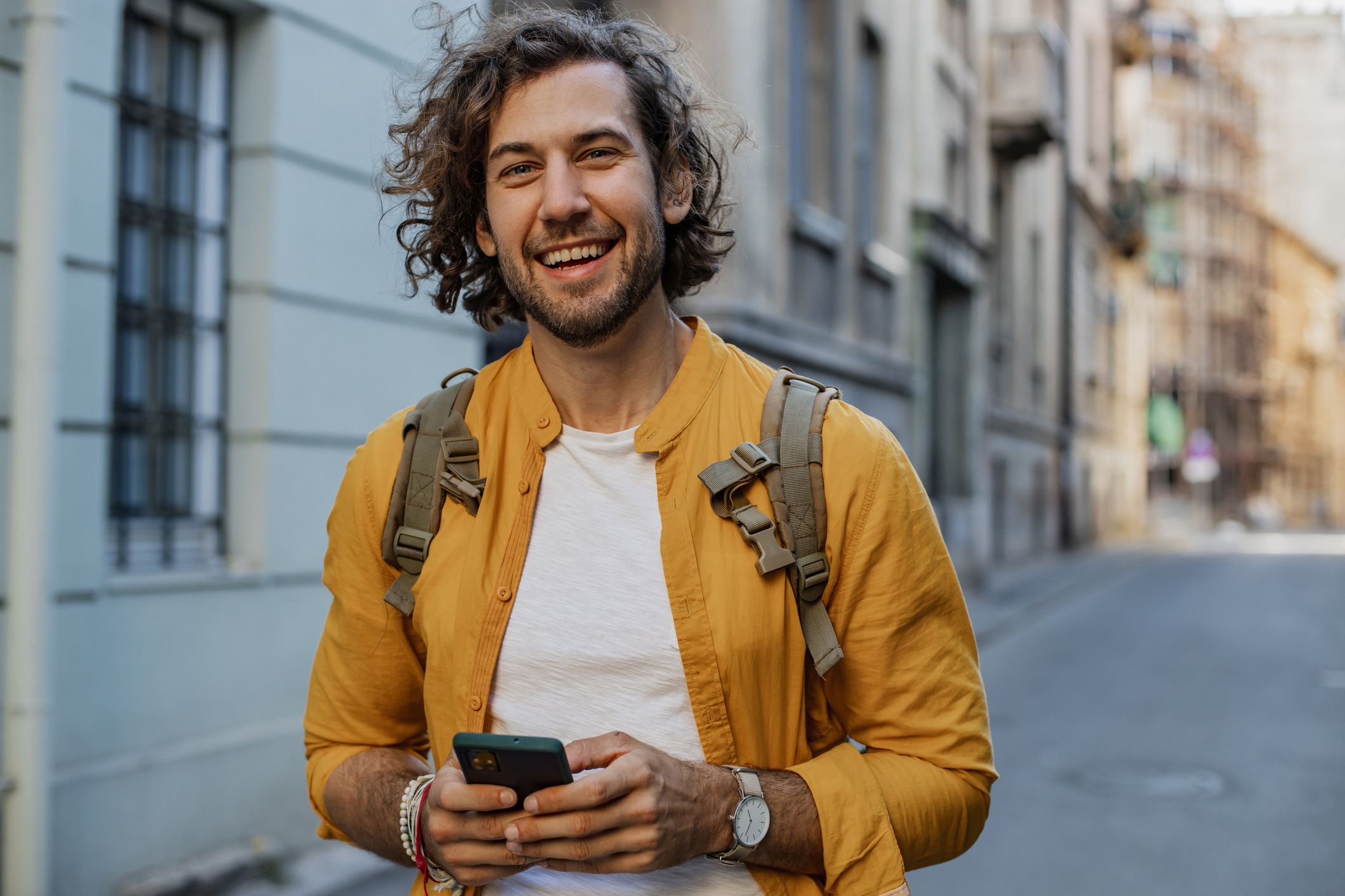 Man Looking At Camera With Phone